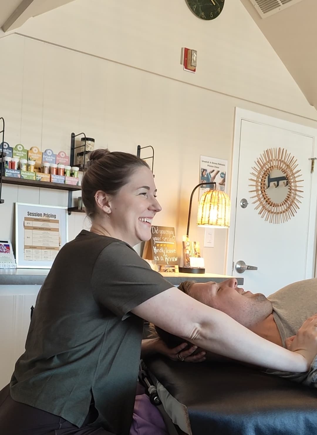 Chelsea guiding an assisted stretch in the Williamsville studio