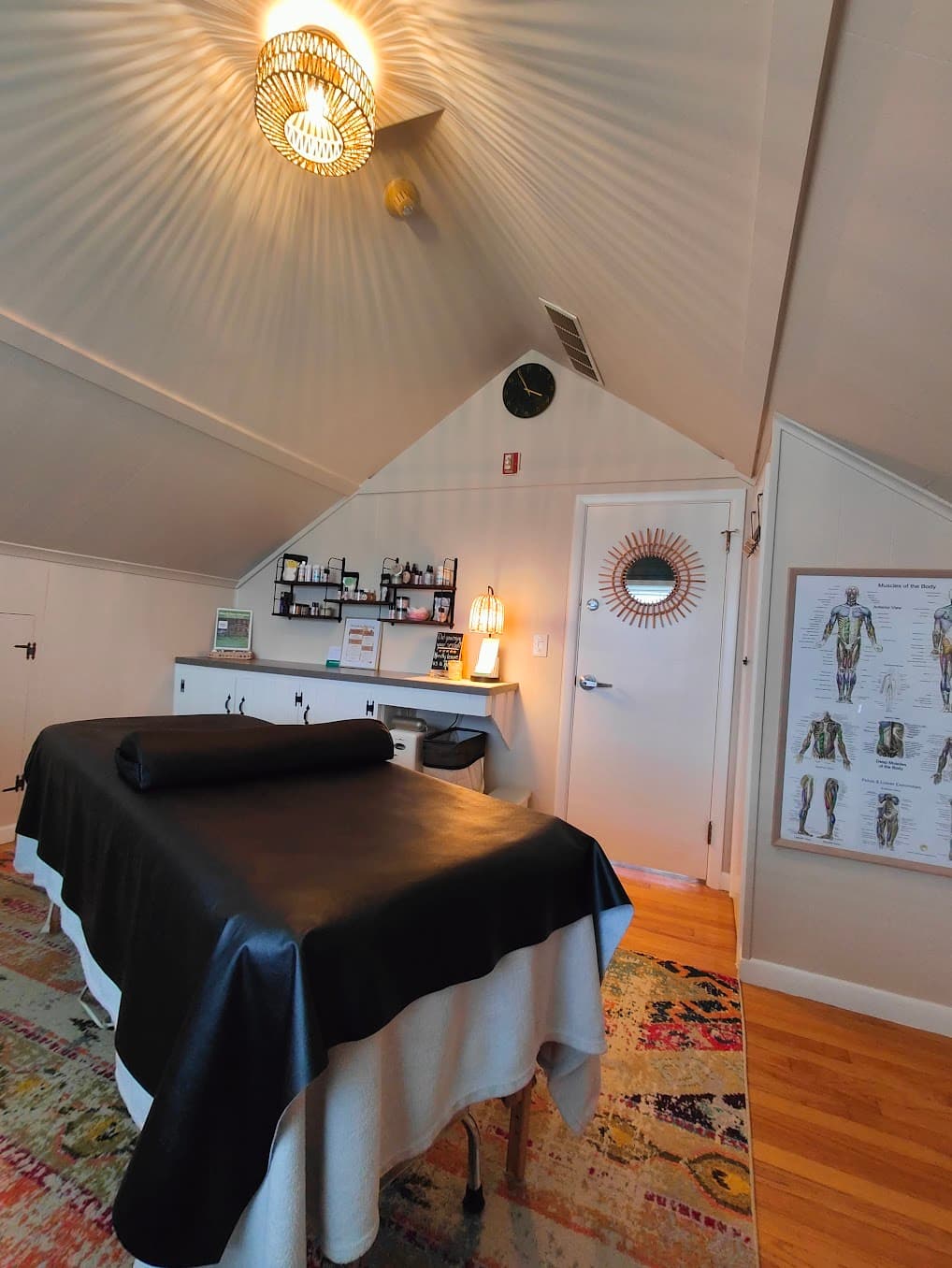 The assisted-stretch table beneath the studio's vaulted ceiling